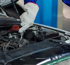 Mechanic performing MOT test on a car in Southall garage